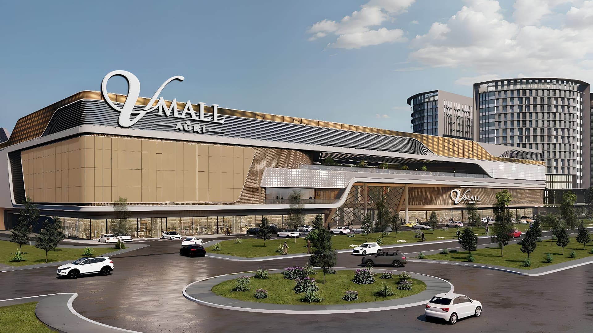 V Mall Ağrı'nın gündüz render görseli: çatıdaki V Mall Ağrı tabelası, altın rengi cephe panelleri ve önde çevre yolu ile otopark