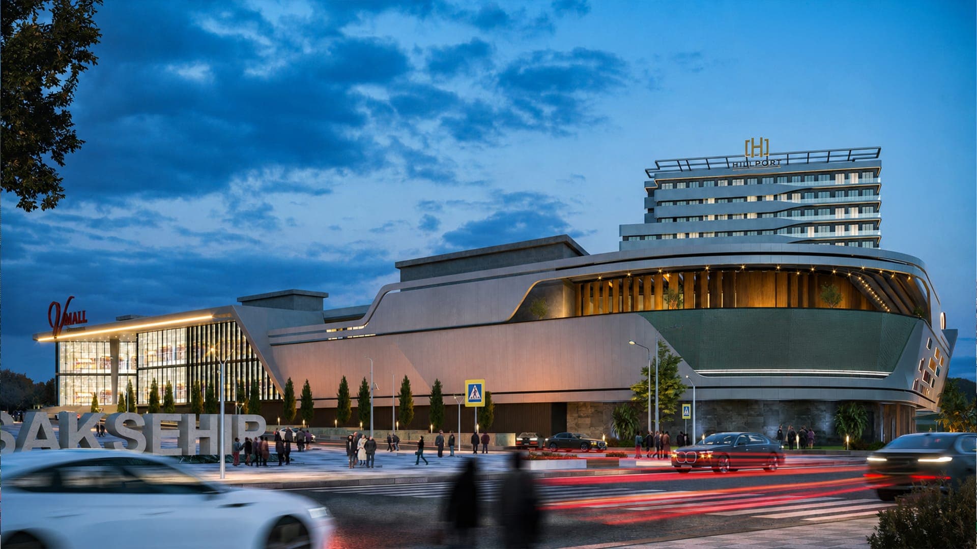 V Mall İstanbul'un akşam render görseli: aydınlatılmış cephe, üzerindeki Hillport oteli ve önde Başakşehir harfleri